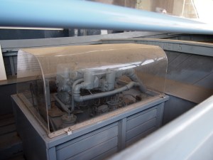 The diesel engine (under showcase for display) which powered the motor whaleboat. 